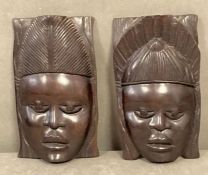 Two pairs of Ebony African face mask, wall hangings