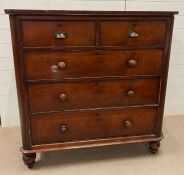 Two over three chest of drawers with cup handles to the top drawers and turned feet