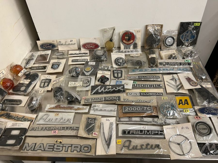 A large selection of motor memorabilia including badges, mini door handles, winders, Morris 8
