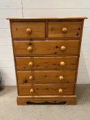 A pine chest of drawers, two over four (H112cm W83cm D44cm)