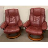 A pair of stressless burgundy chairs made by Ekornes made in Norway