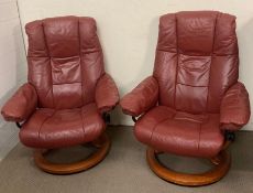 A pair of stressless burgundy chairs made by Ekornes made in Norway