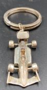A silver Formula 1 key ring.