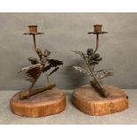 A Pair of brass candlesticks in the form of of acorn branches on oak plinths