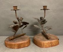 A Pair of brass candlesticks in the form of of acorn branches on oak plinths