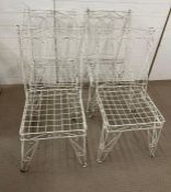 A Wrought Iron scrolling weathered table with Four vintage matching chairs both with hair pin legs