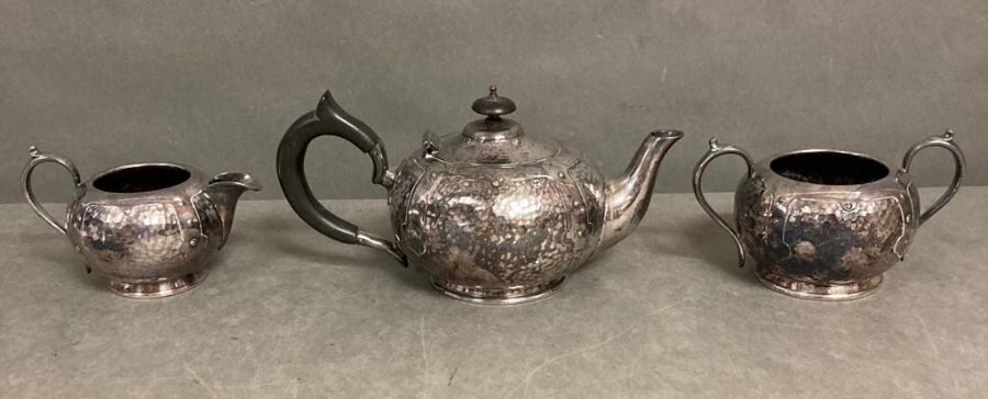 An Arts and Crafts Tea service comprising teapot, sugar bowl and milk jug