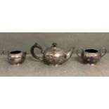 An Arts and Crafts Tea service comprising teapot, sugar bowl and milk jug