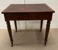 A William IV writing table on octagonal legs terminating on brass castors