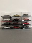 Twelve boxed Rally and Racing diecast vehicles.