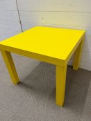 A square side table in yellow