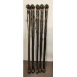 Five ebony and gilt style pillar curtain rods (167cm end to end)