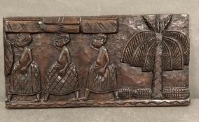 A carved wooden African wall hanging (61cm x 31cm)