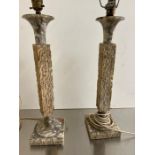 A pair of column textured lamps with marble tops