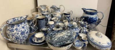 A mixed selection of blue and white china to include jugs and cups
