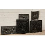 A selection of cast iron wall hangings to include an ornate oven door