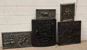 A selection of cast iron wall hangings to include an ornate oven door