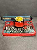 A vintage tin typewriter toy