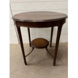 A mahogany centre table with reeded legs and raised shelf under (H72cm Dia70cm)