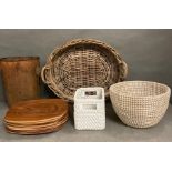 A selection of soft furnishings to include a wicker tray, woven baskets, place mats, a vintage waste