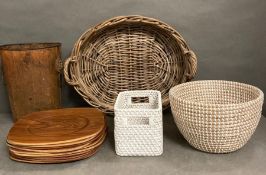 A selection of soft furnishings to include a wicker tray, woven baskets, place mats, a vintage waste