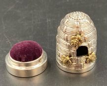 A silver pin cushion and thimble in the form of a beehive
