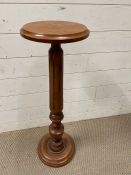 A lamp stand or plant stand with turned pillar support