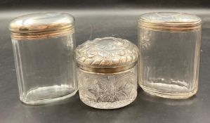 Three Silver topped glass jars