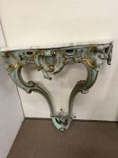A marble topped Rococo frame with scrolling leaf decoration (H94cm W87cm D36cm)