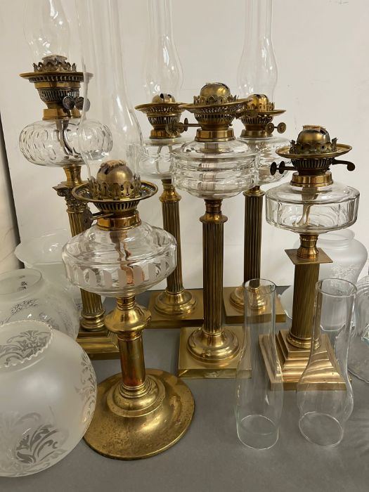 Six brass oil lamps with etched, clear and crimped shades (H54cm)