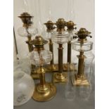 Six brass oil lamps with etched, clear and crimped shades (H54cm)