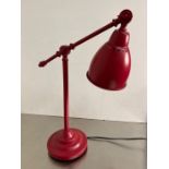 A red Ikea desk lamp