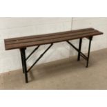 A collapsible metal bench seat with wooden slats