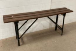 A collapsible metal bench seat with wooden slats