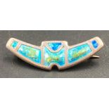A silver and enamel brooch by Charles Horner