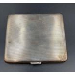 A silver cigarette case, hallmarked for Birmingham 1937 by William Neale