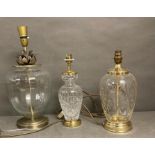 Three lamp bases to include two brass and a cut glass one with pineapple motif.