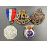 A selection of military medals, badges and insignia to include a WWI Tank Corp, 1935 Silver