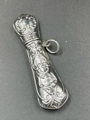An ornate silver needle case