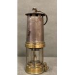 An antique brass miners lamp