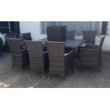 A rattan eight seat garden table and chairs with small side table (H74cm W150cm D100cm)