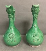 A pair of 19th Century, Ottoman revival, canakkale, green glazed terracotta ewers