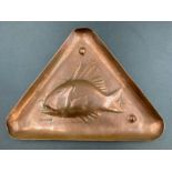 A Newlyn copper triangular pin dish with fish motif.