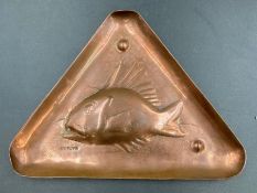 A Newlyn copper triangular pin dish with fish motif.