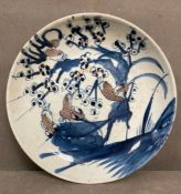 A Chinese Qing jiaqing blue and white plate with birds in copper red (Dia25cm)