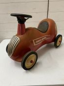 A metal radio flyer ride on children's car toy