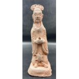 An antique Chinese terracotta figure, marked to base