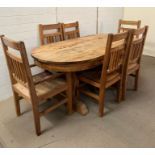 An oval rustic pine table with three drawers, four chairs and two carvers (H75cm W200cm D100cm)