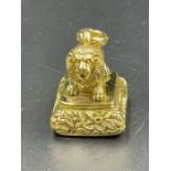 A Gilt Metal seal in the form of a lion.