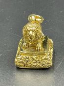 A Gilt Metal seal in the form of a lion.